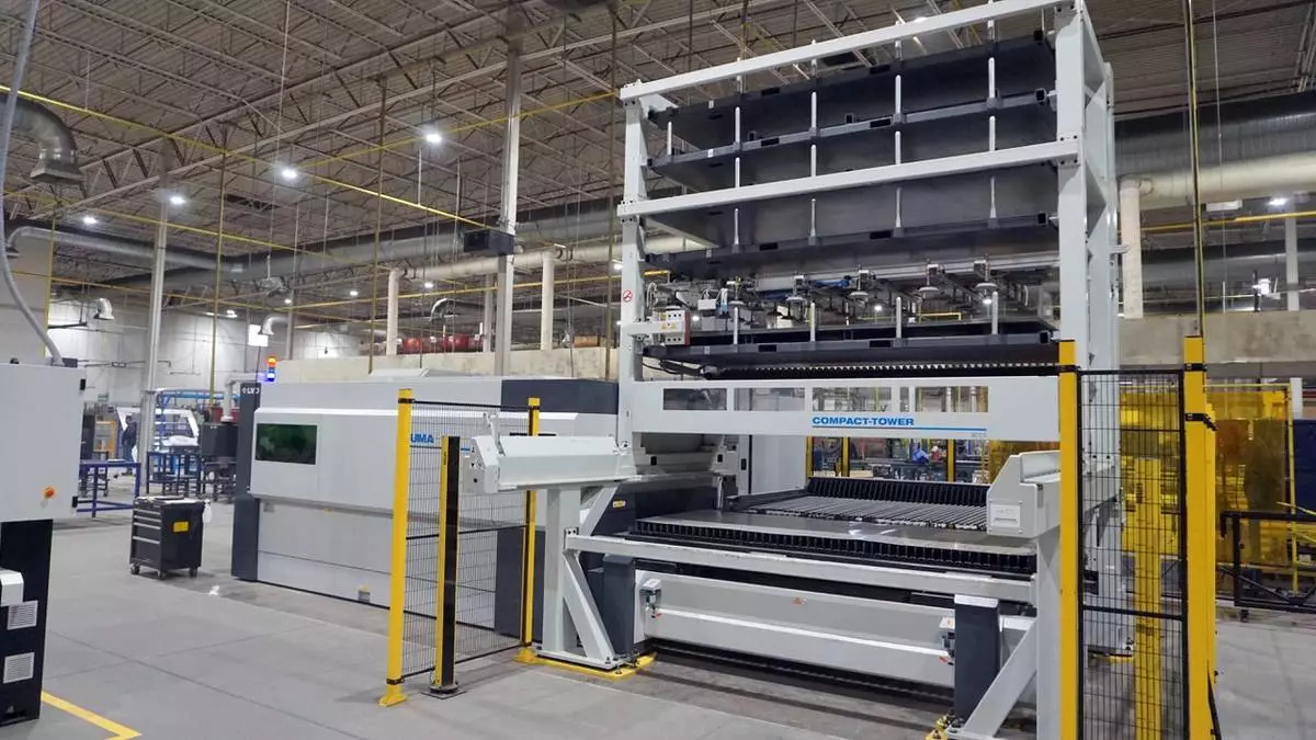 Automated laser cutting system and material storage tower in Komacut’s Mexico facility, designed for high-volume precision manufacturing.