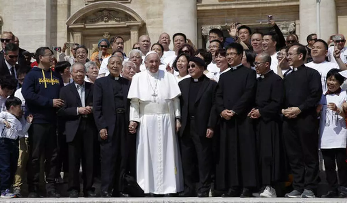 FILE - Pope Francis poses a group of faithful and bishops from Shanghai during his weekly general audience in St. Peter's square at the Vatican Wednesday, May 22, 2019. (AP Photo/Alessandra Tarantino, File)