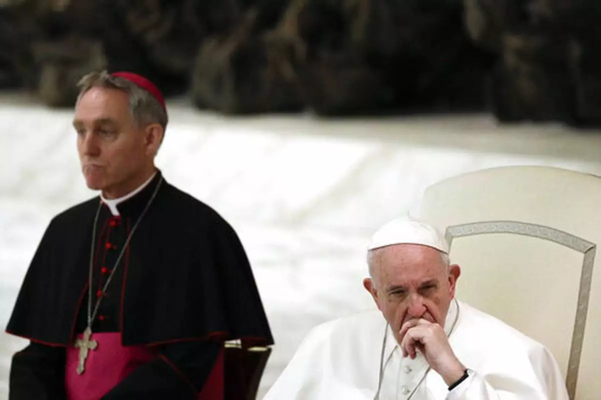 FILE - Pope Francis, flanked by Monsignor Georg Gaenswein, listens to a faithful's speech on the occasion of an audience in the Paul VI hall at the Vatican, Friday, March 22, 2019. (AP Photo/Gregorio Borgia, file)
