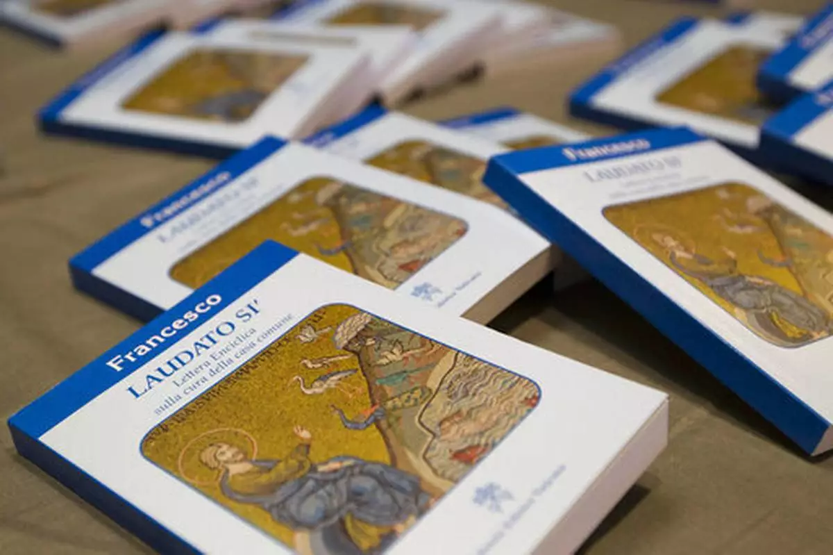 FILE - Copies of Pope Francis' encyclical "Laudato Si," (Praise Be) are displayed prior to the start of a press conference, at the Vatican, Thursday, June 18, 2015. (AP Photo/Andrew Medichini, file)