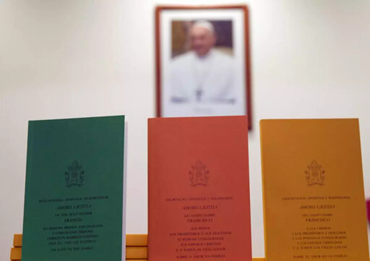 FILE - Copies of the post-synodal apostolic exhortation ' Amoris Laetitia ' (The Joy of Love) document by Pope Francis are on display prior to the start of a press conference, at the Vatican, Friday, April 8, 2016. (AP Photo/Andrew Medichini, file)