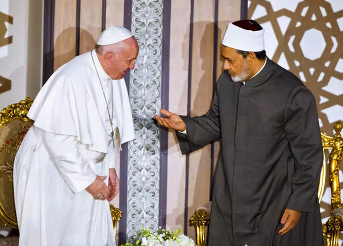 FILE - Sheikh Ahmed el-Tayeb, right, Grand Imam of Al-Azhar, the pre-eminent institute of Islamic learning in the Sunni Muslim world, right, welcomes Pope Francis at the international peace conference in Cairo, Egypt, Friday, April 28, 2017. (AP Photo/Amr Nabil, file)