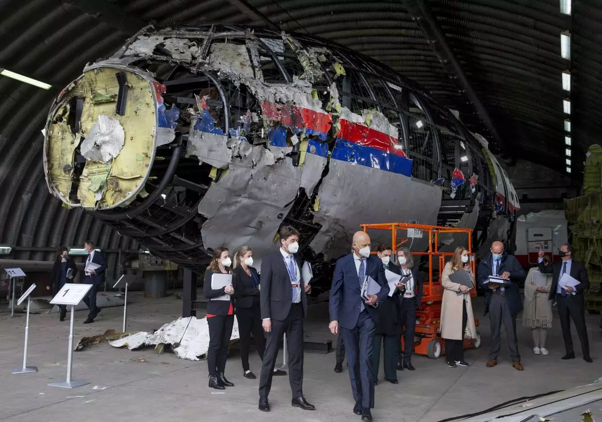 FILE - Judges and lawyers view the wreckage of a Malaysia Airlines passenger jet at the Gilze-Rijen Air Base, Netherlands, on May 26, 2021. (AP Photo/Peter Dejong, Pool, File)