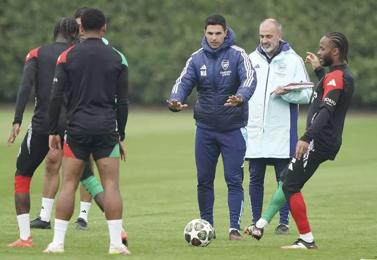 Arsenal manager Mikel Arteta, center, gestures during a training session in London, England, Tuesday, April 15, 2025, ahead of the Champions League soccer match between Real Madrid and Arsenal London. (Jonathan Brady/PA via AP)
