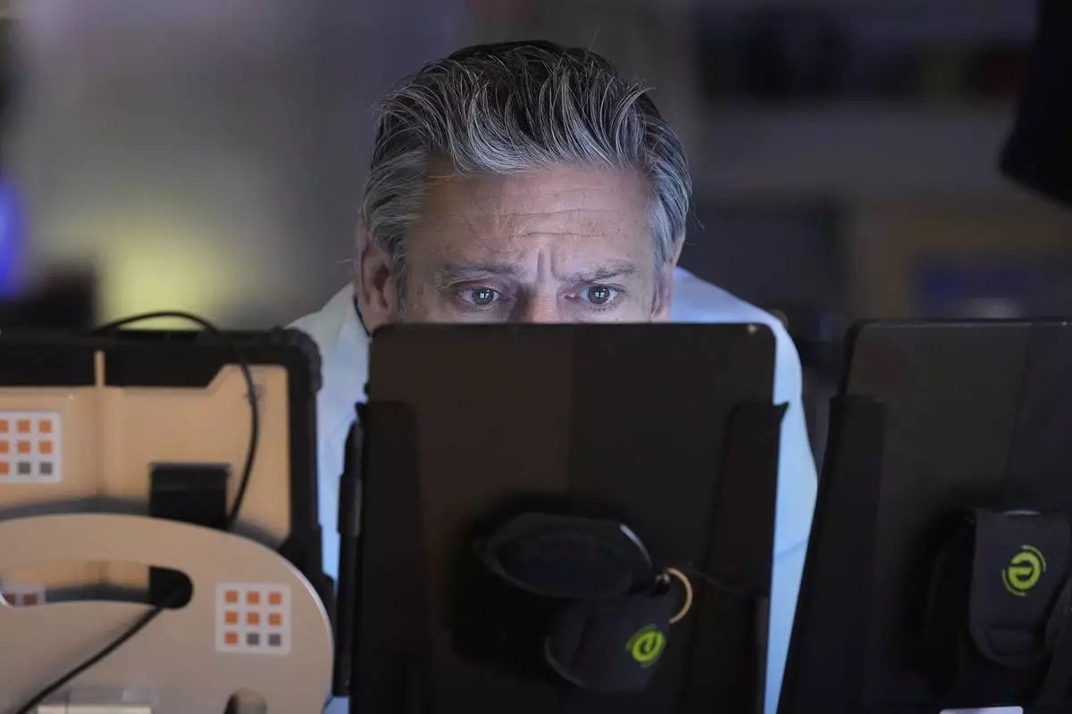 Trader John Romolo works on the floor of the New York Stock Exchange, Friday, April 25, 2025. (AP Photo/Richard Drew)