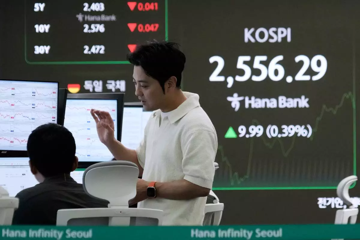 Currency traders work near a screen showing the Korea Composite Stock Price Index (KOSPI) at the foreign exchange dealing room of the KEB Hana Bank headquarters in Seoul, South Korea, Monday, April 28, 2025. (AP Photo/Ahn Young-joon)