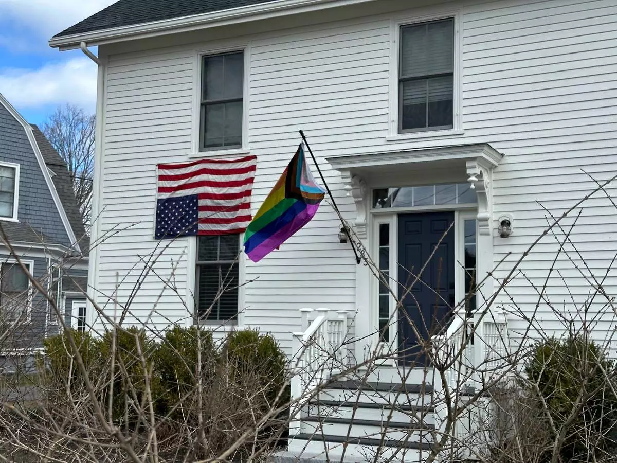 This house in Cumberland, Maine, shows a home with an LGBTQ pride flag and an upside down American flag, Wednesday, Aprill 16, 2025. (AP Photo/Patrick Whittle)