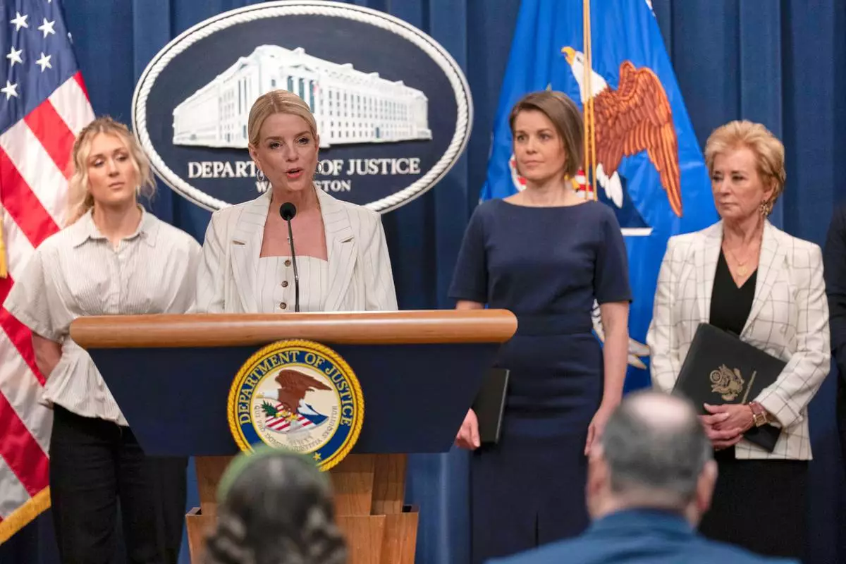Attorney General Pam Bondi accompanied by from left Riley Gaines Rep. Laurel Libby R-Maine, and Education Secretary Linda McMahon speaks during a news conference to announce that the administration it is suing Maine’s education department for not complying with the government's push to ban transgender athletes in girls sports, at the Department of Justice headquarters in Washington, Wednesday, April 16, 2025. (AP Photo/Jose Luis Magana)