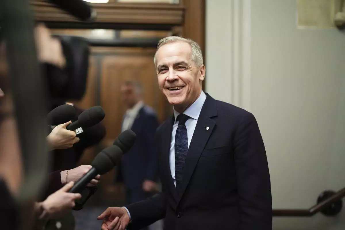 FILE - Canada Liberal Leader Mark Carney talks to the media as he leaves the prime minister's office and makes his way to a caucus meeting in Ottawa on March 10, 2025. (Sean Kilpatrick/The Canadian Press via AP, File)