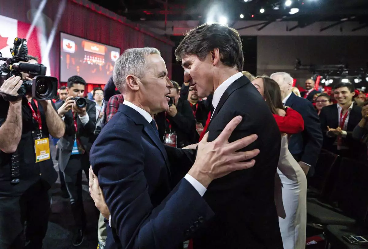 FILE - Mark Carney, Leader of the Liberal Party of Canada, embraces Prime Minister Justin Trudeau after being announced the winner at the Liberal Leadership Event in Ottawa, Ontario, March 9, 2025. (Justin Tang/The Canadian Press via AP, File)