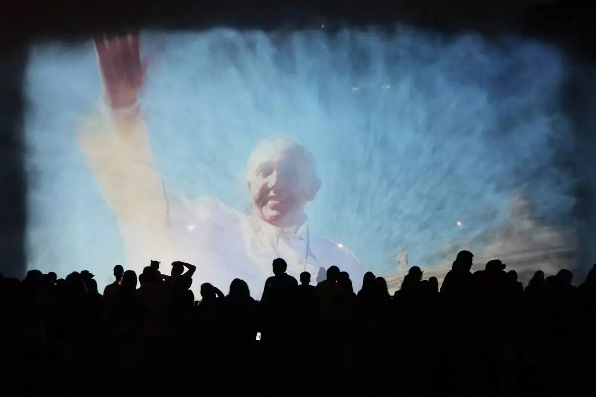 A portrait of the late Pope Francis is projected onto a water fountain at Magic Water Circuit in Lima, Peru, Monday, April 21, 2025. (AP Photo/Martin Mejia)