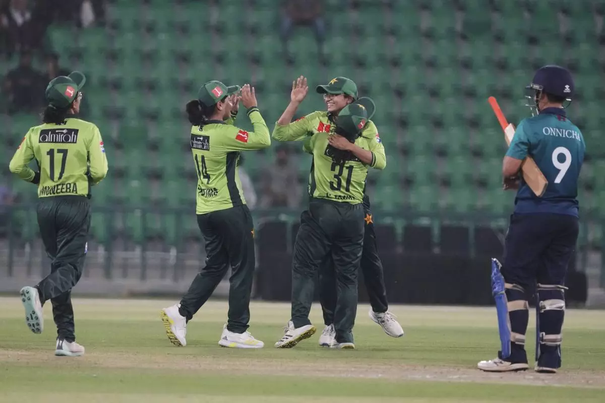 Pakistani players celebrate their win at the ICC Women's World Cup Qualifier match against Thailand in the Gaddafi Stadium, in Lahore, Pakistan, Thursday, April 17, 2025. (AP Photo/K.M. Chaudary)