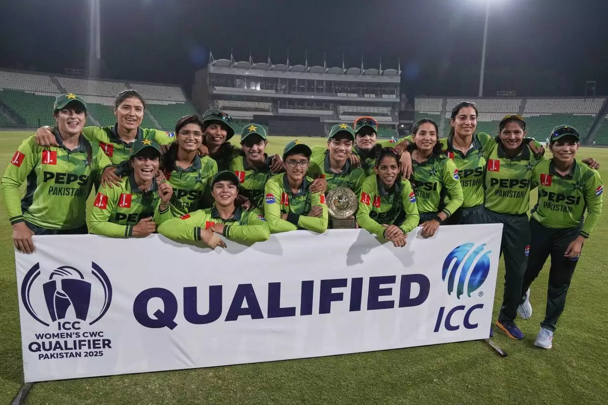 Pakistani players pose for photograph after winning the match against Thailand and qualifying for ICC Women's World Cup, at the Gaddafi Stadium, in Lahore, Pakistan, Thursday, April 17, 2025. (AP Photo/K.M. Chaudary)