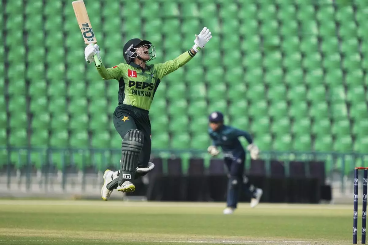 Pakistan's Sidra Amin celebrates after scoring fifty during the ICC Women's World Cup Qualifier match between Pakistan and Thailand at the Gaddafi Stadium, in Lahore, Pakistan, Thursday, April 17, 2025. (AP Photo/K.M. Chaudary)