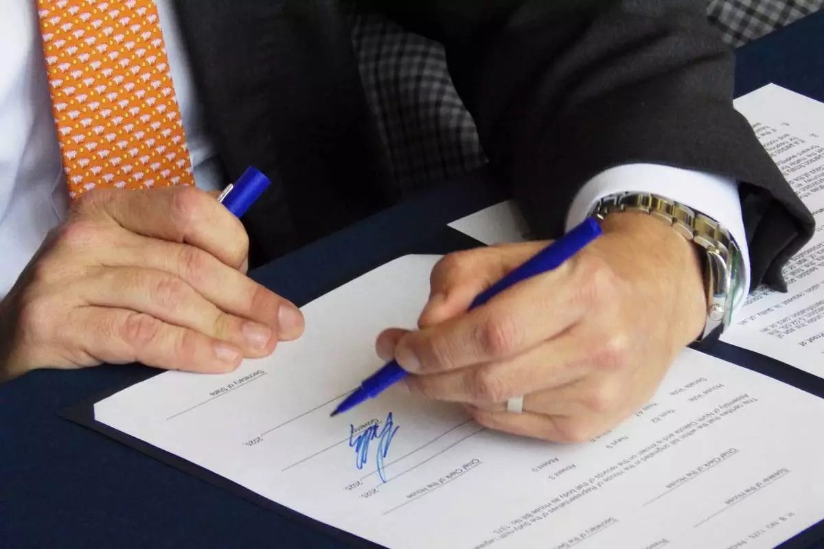 North Dakota Republican Gov. Kelly Armstrong signs a bill on Wednesday, April 23, 2025, at the state Capitol in Bismarck, N.D. (AP Photo/Jack Dura Jack)