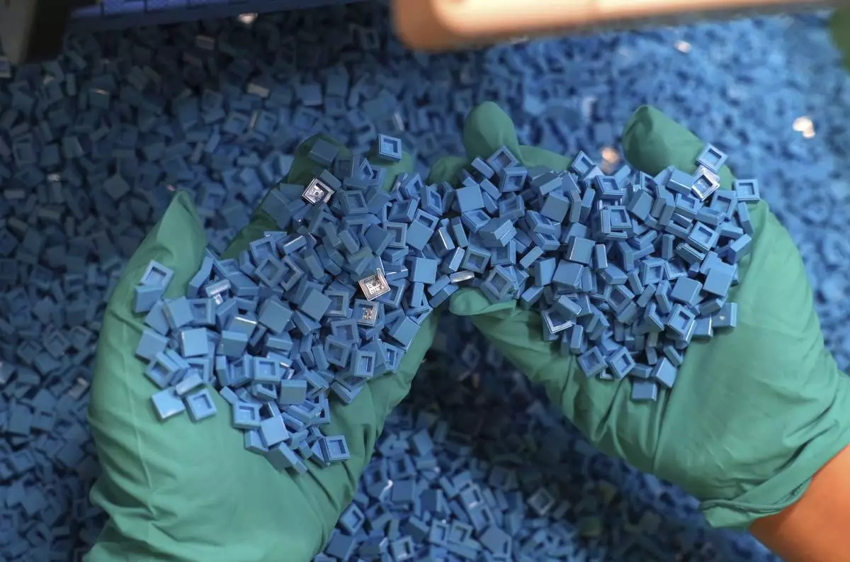 Lego bricks are held in a worker's hands for checking at Lego factory in Binh Duong, Vietnam Wednesday, April 2, 2025. (AP Photo/Hau Dinh)