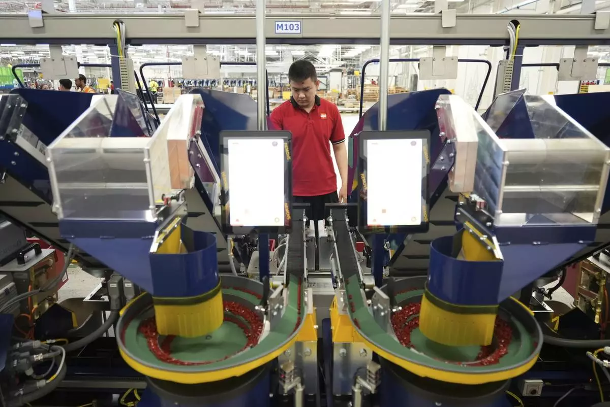 A worker operates packing machines at Lego factory in Binh Duong, Vietnam Wednesday, April 2, 2025. (AP Photo/Hau Dinh)