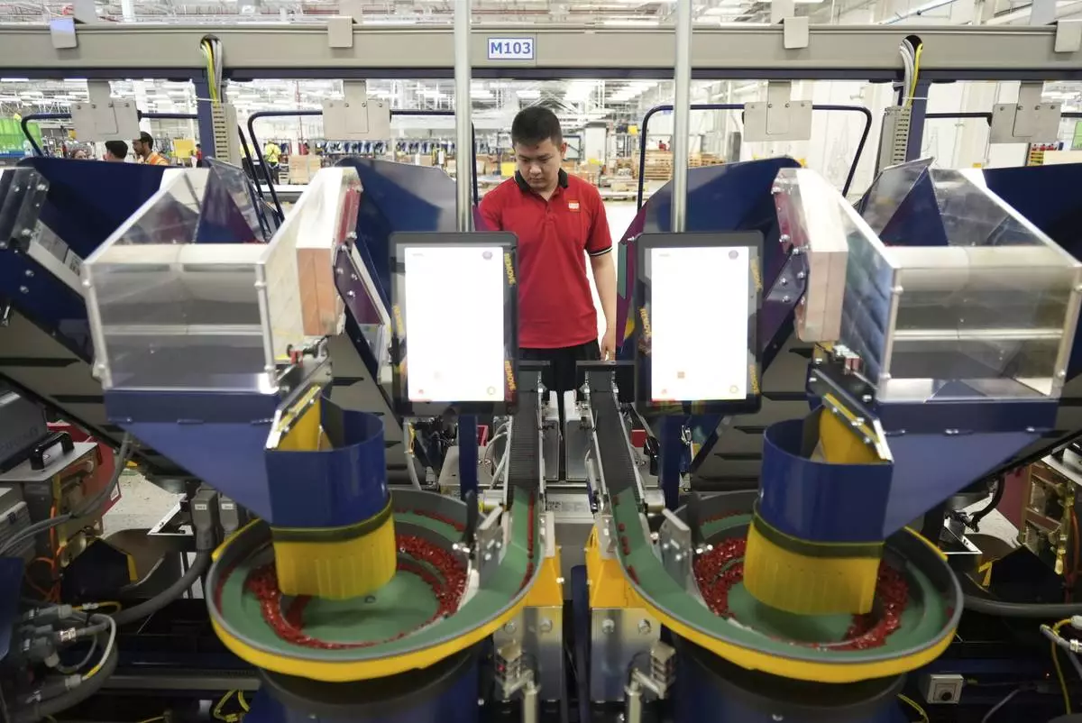 A worker operates packing machines at Lego factory in Binh Duong, Vietnam Wednesday, April 2, 2025. (AP Photo/Hau Dinh)