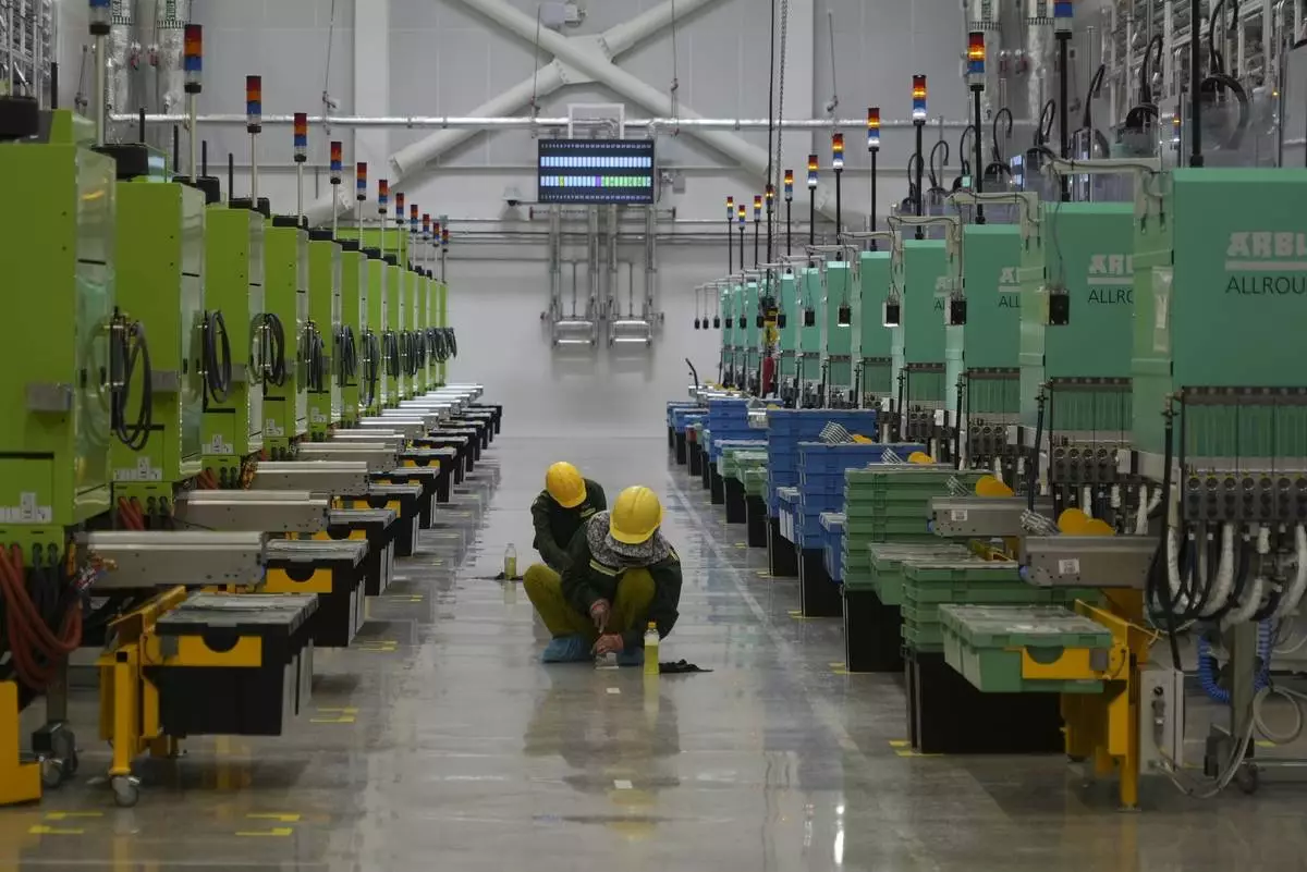 Workers scrub the floor at Lego factory in Binh Duong, Vietnam Wednesday, April 2, 2025. (AP Photo/Hau Dinh)
