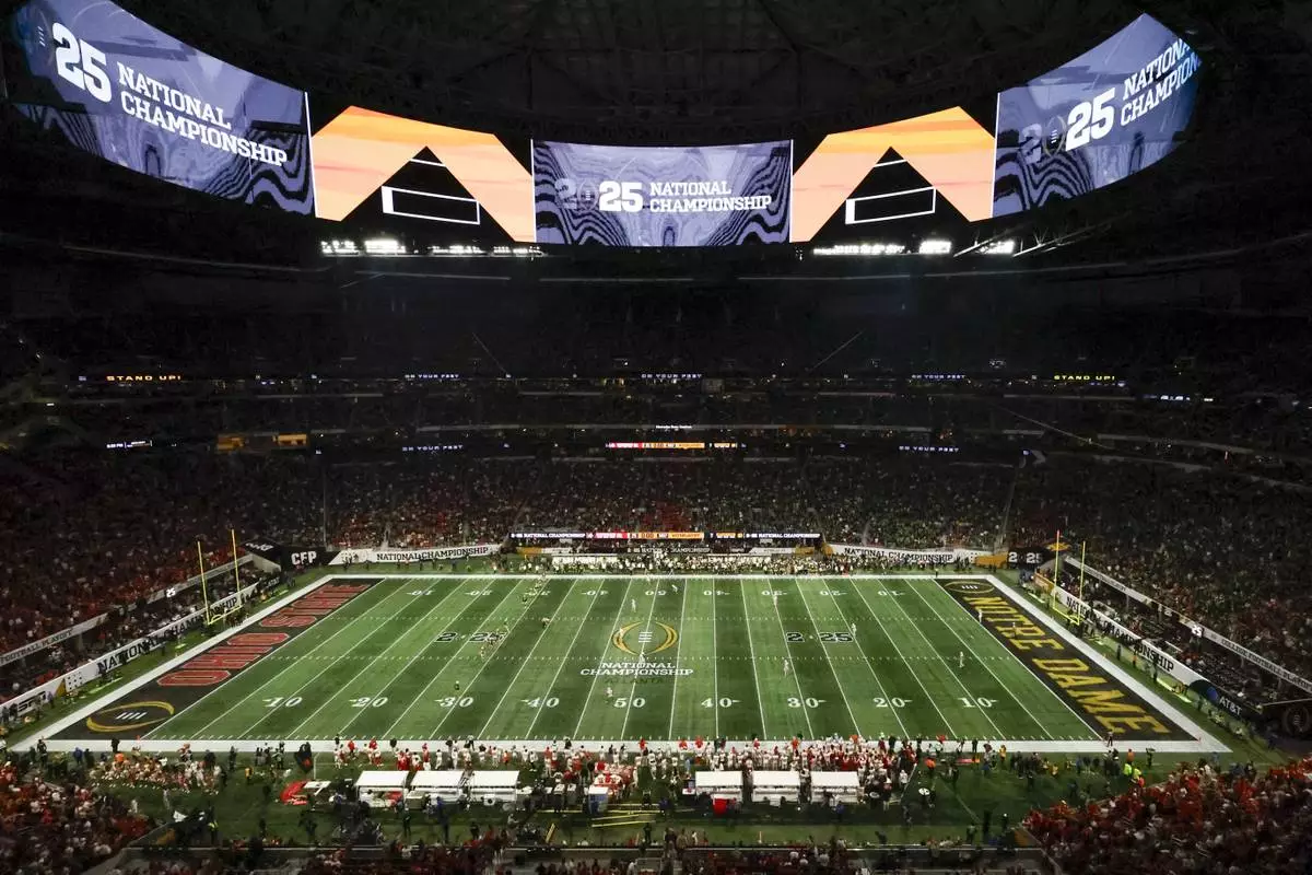 FILE - Fans watch during second half of the College Football Playoff national championship game between Ohio State and Notre Dame, Jan. 20, 2025, in Atlanta. (AP Photo/Butch Dill, File)