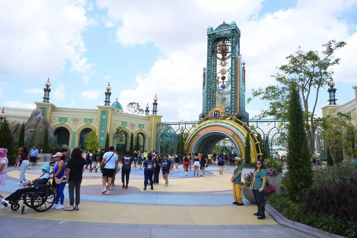 Guests arrive at the main entrance to Epic Universe Theme Park at Universal Resort Orlando Thursday, April 10, 2025, in Orlando, Fla. (AP Photo/John Raoux)