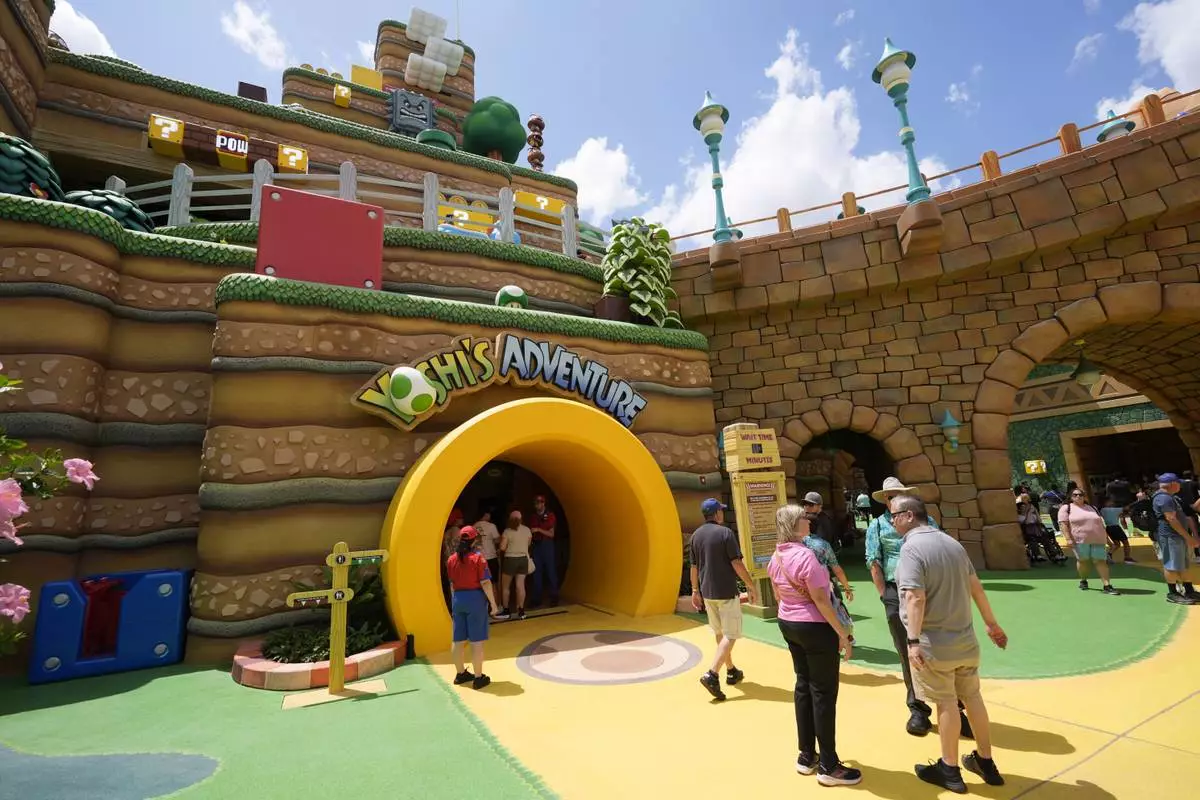 Guests stroll around the various parts of Super Nintendo World at Epic Universe at Universal Resort Orlando Thursday, April 10, 2025, in Orlando, Fla. (AP Photo/John Raoux)