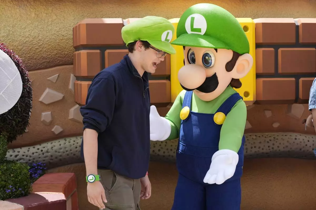 A guest interacts with a character in Super Nintendo World at Epic Universe at Universal Resort Orlando Thursday, April 10, 2025, in Orlando, Fla. (AP Photo/John Raoux)