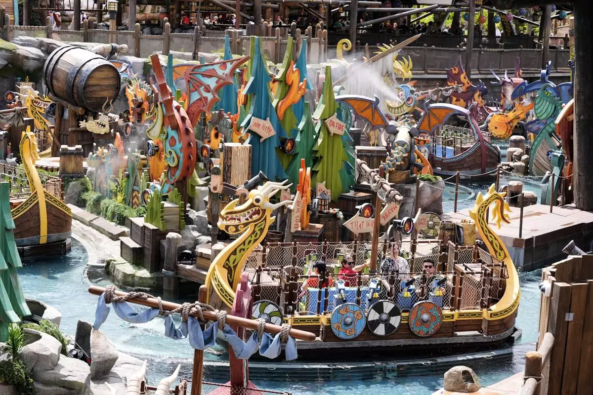 Park guests ride the Fyre Drill boat ride at How to Train Your Dragon – Isle of Berk at Epic Universe Theme Park at Universal Resort Orlando Thursday, April 10, 2025, in Orlando, Fla. (AP Photo/John Raoux)