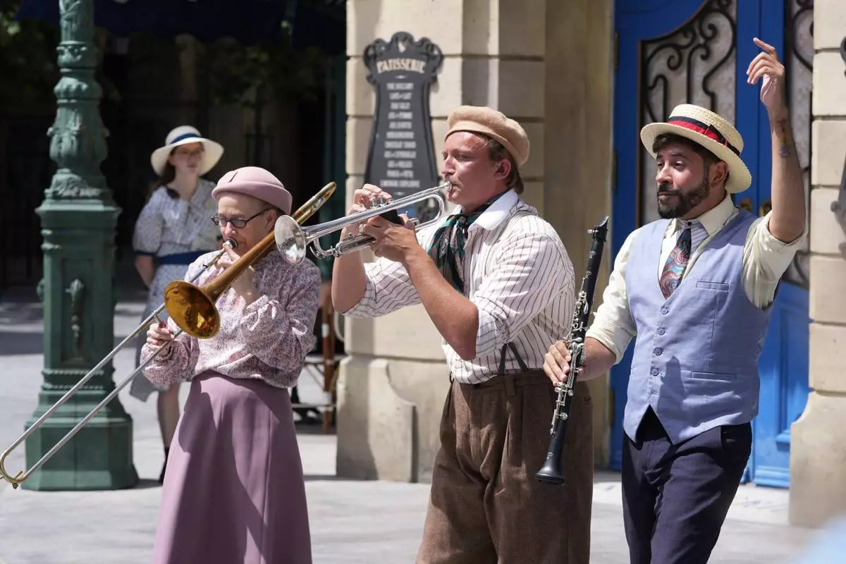Street musicians perform for guests at The Wizarding World of Harry Potter, Ministry of Magic at Epic Universe at Universal Resort Orlando Thursday, April 10, 2025, in Orlando, Fla. (AP Photo/John Raoux)