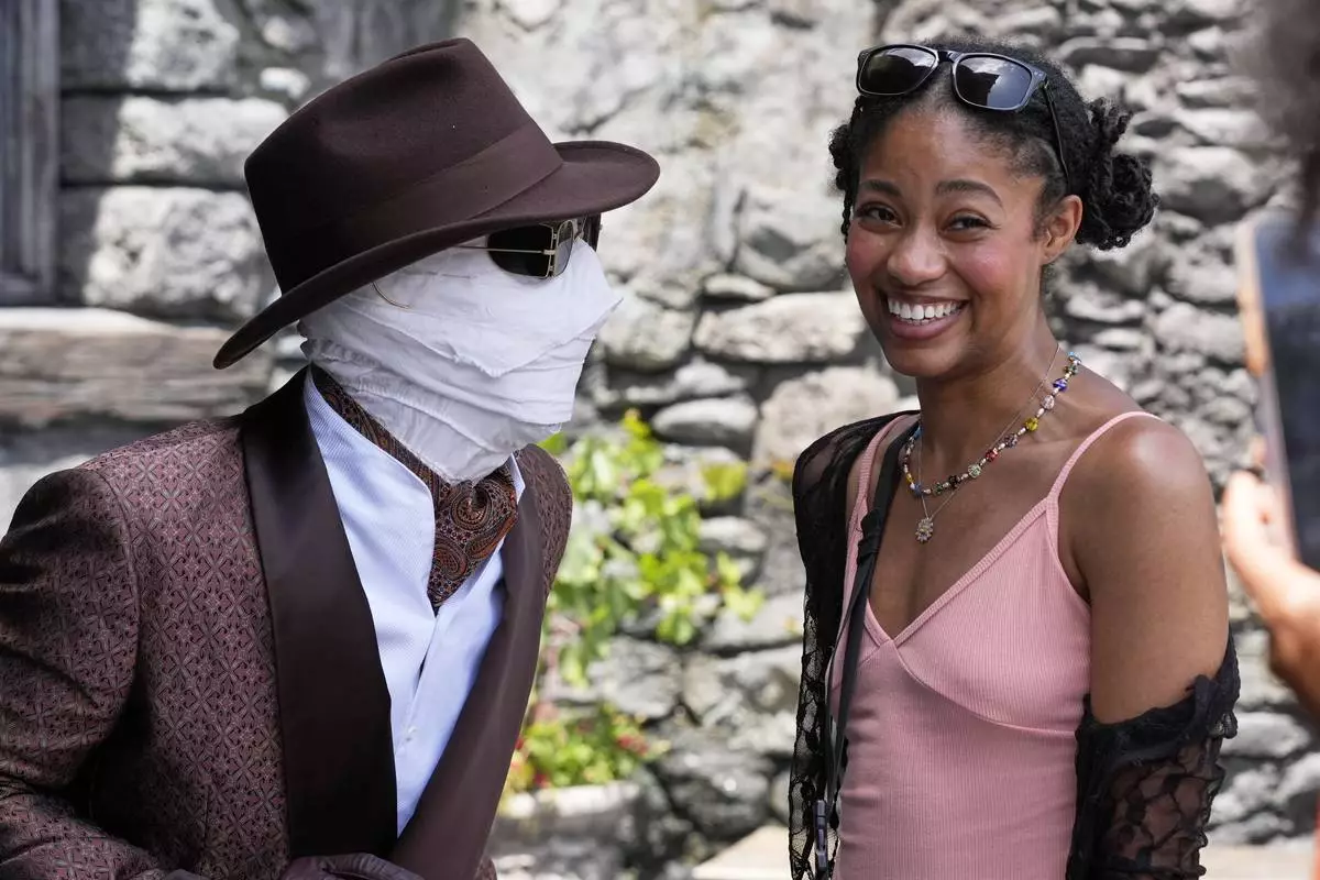 The invisible man interacts with a guest in Dark Universe at Epic Universe Theme Park at Universal Resort Orlando Thursday, April 10, 2025, in Orlando, Fla. (AP Photo/John Raoux)