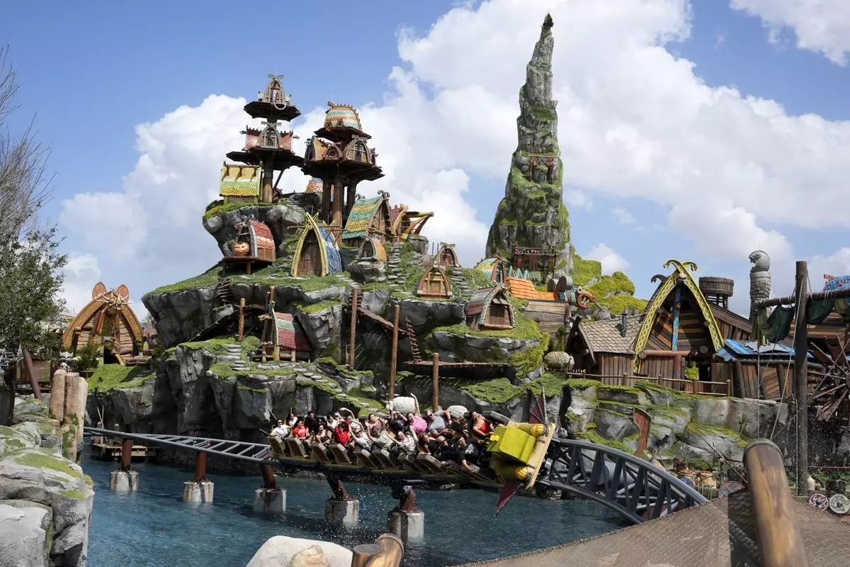 Guest ride a roller coaster in the How To Train Your Dragon – Isle Of Berk at Epic Universe theme park at Universal Resort Orlando Thursday, April 10, 2025, in Orlando, Fla. (AP Photo/John Raoux)