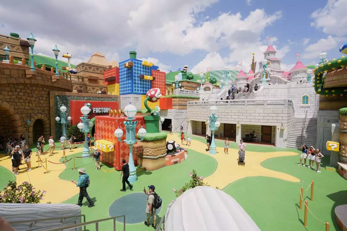 Guests stroll around the various parts of Super Nintendo World at Epic Universe at Universal Resort Orlando Thursday, April 10, 2025, in Orlando, Fla. (AP Photo/John Raoux)