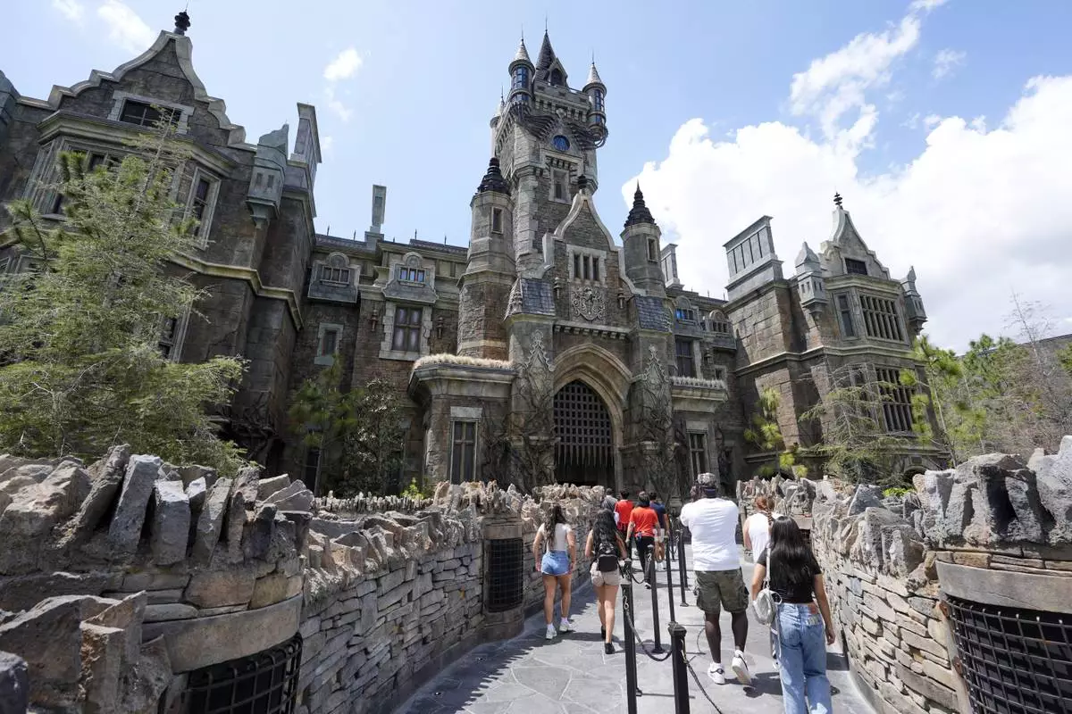 Guests enter the The Frankenstein Castle in Dark Universe at Epic Universe Theme Park at Universal Resort Orlando Thursday, April 10, 2025, in Orlando, Fla. (AP Photo/John Raoux)