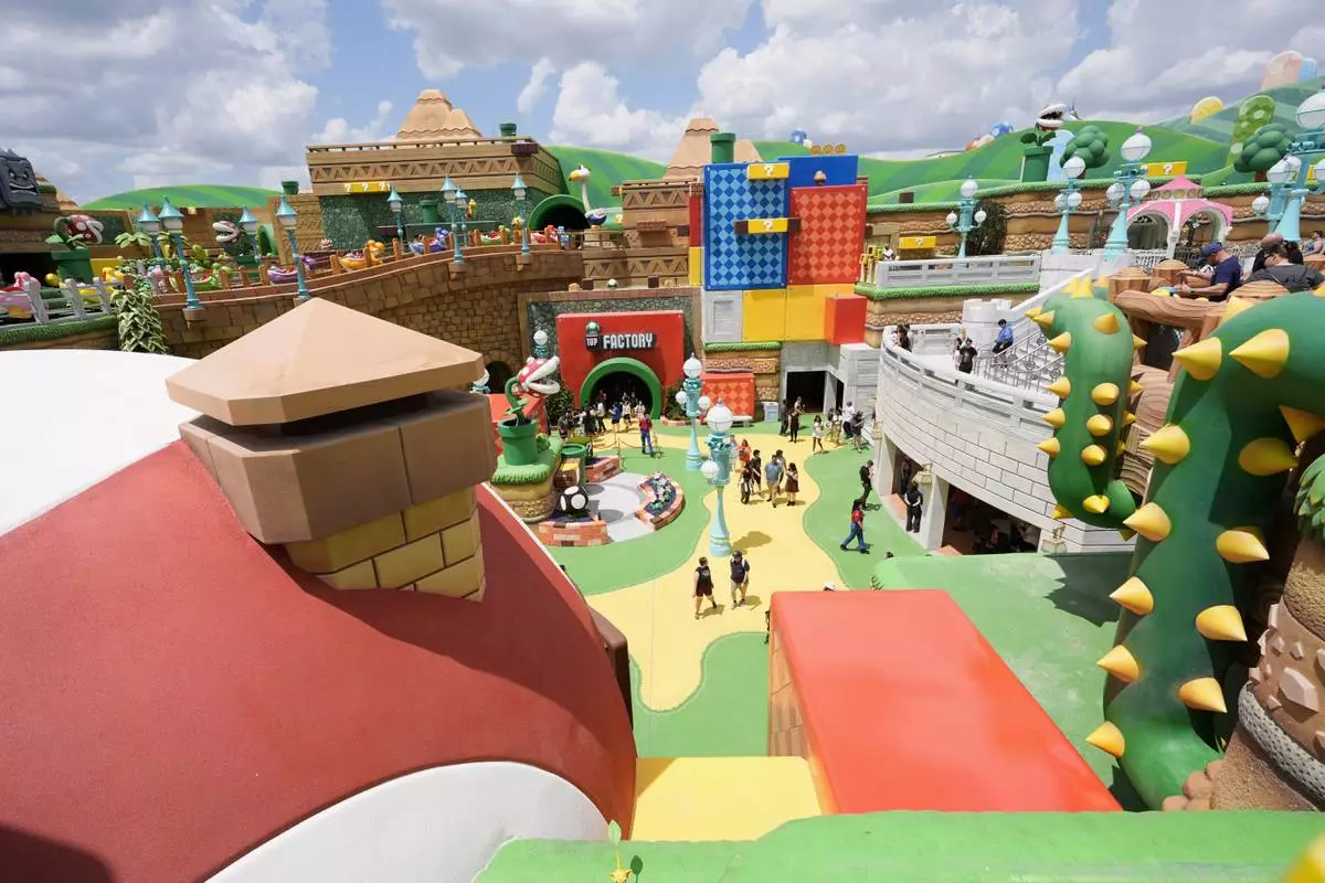 Guests stroll around the various parts of Super Nintendo World at Epic Universe at Universal Resort Orlando Thursday, April 10, 2025, in Orlando, Fla. (AP Photo/John Raoux)