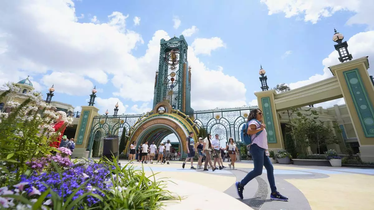 Guests arrive at the main entrance to Epic Universe Theme Park at Universal Resort Orlando Thursday, April 10, 2025, in Orlando, Fla. (AP Photo/John Raoux)