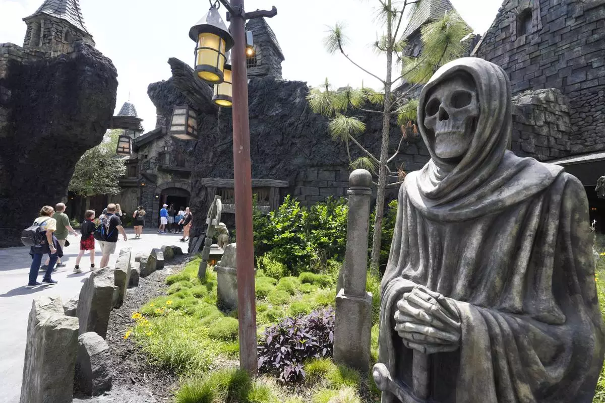 Guests tour the Dark Universe at Epic Universe Theme Park at Universal Resort Orlando Thursday, April 10, 2025, in Orlando, Fla. (AP Photo/John Raoux)