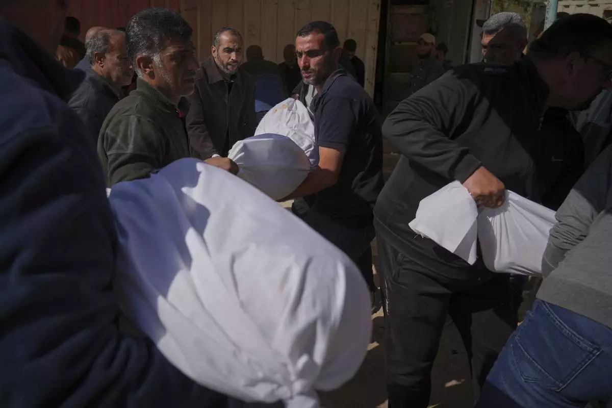 Palestinians prepare for burial the bodies of several members of the al-Atal family, killed in an Israeli airstrike on a tent in the Jabalia refugee camp, at the Indonesian hospital in Beit Lahia, northern Gaza Strip, Thursday, April 17, 2025.(AP Photo/(AP Photo/Jehad Alshrafi)