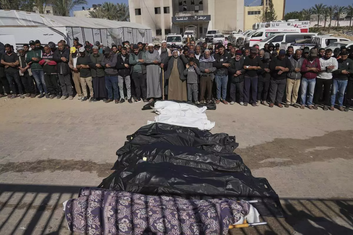 Mourners pray over the bodies of 10 members of the Abu Al-Rous family, killed when an Israeli airstrike struck their displacement tent overnight, during their funeral in Khan Younis, southern Gaza Strip, Thursday, April 17, 2025. (AP Photo/Abdel Kareem Hana)