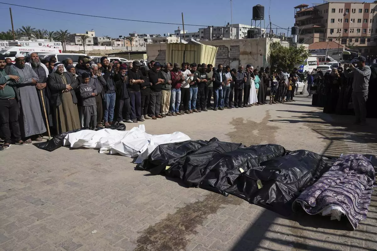 Mourners pray over the bodies of 10 members of the Abu Al-Rous family, killed when an Israeli airstrike struck their displacement tent overnight, during their funeral in Khan Younis, southern Gaza Strip, Thursday, April 17, 2025. (AP Photo/Abdel Kareem Hana)