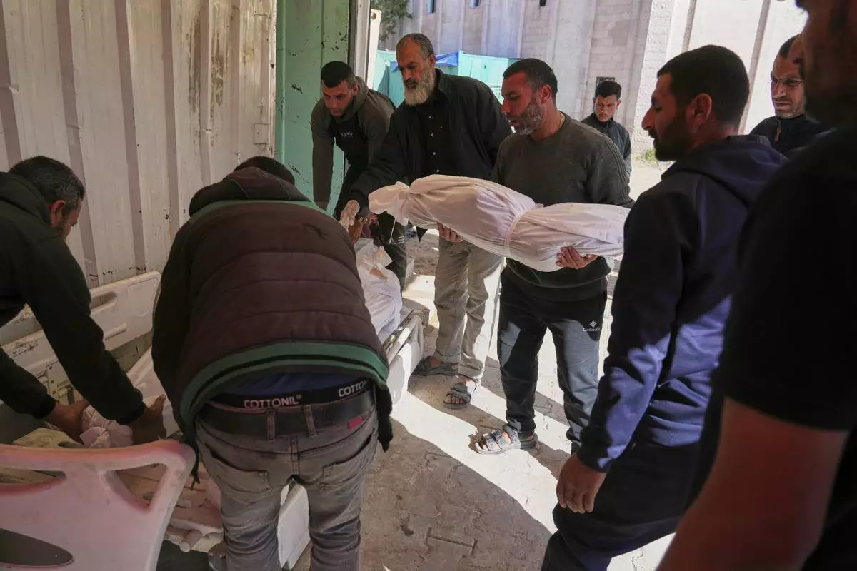 Palestinians prepare for burial the bodies of several members of the al-Atal family, killed in an Israeli airstrike on a tent in the Jabalia refugee camp, at the Indonesian hospital in Beit Lahia, northern Gaza Strip, Thursday, April 17, 2025.(AP Photo/(AP Photo/Jehad Alshrafi)