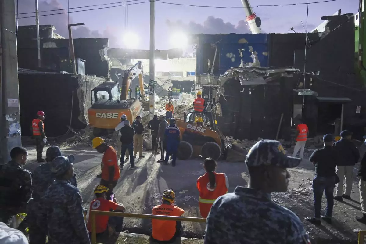Rescue workers search for survivors at the Jet Set nightclub after its roof collapsed two nights prior during a merengue concert in Santo Domingo, Dominican Republic, Wednesday, April 9, 2025. (AP Photo/Ricardo Hernandez)