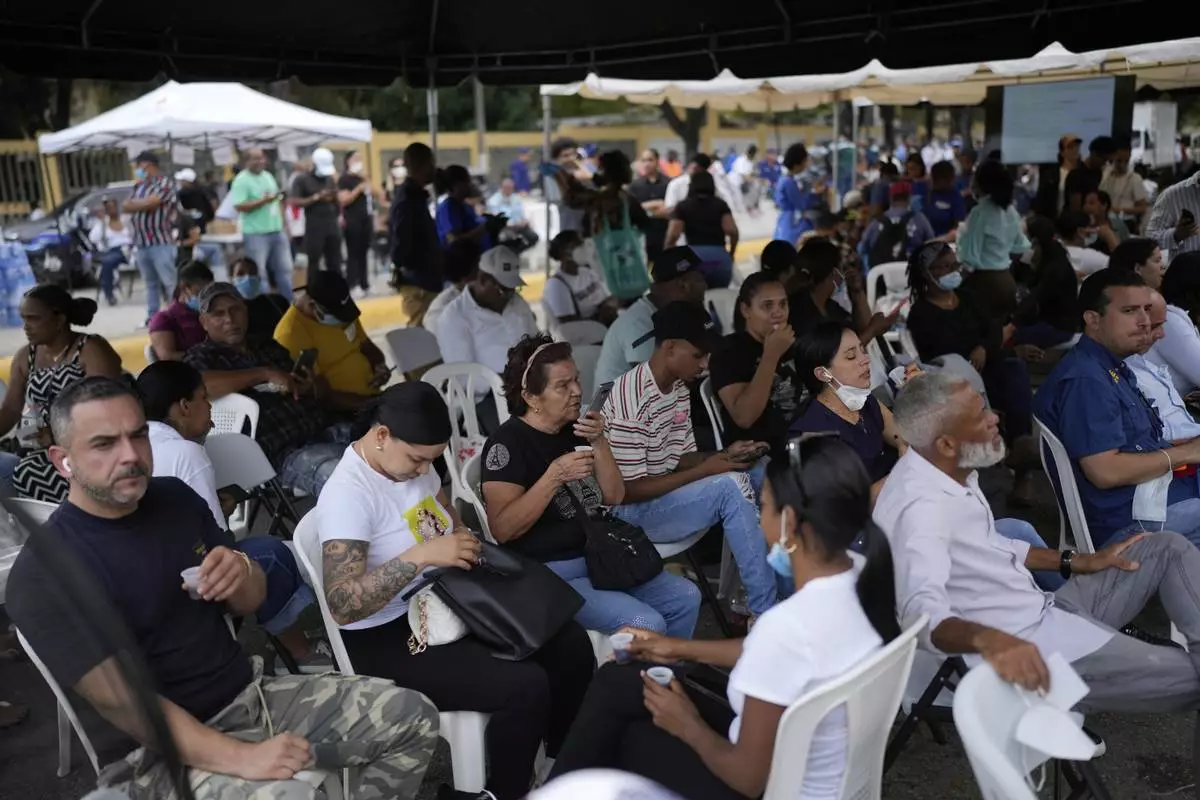 Family members wait to receive the remains of their loved one who died at the Jet Set nightclub days after its roof collapsed, killing more than 200 people, at the National Institute of Forensic Pathology in Santo Domingo, Dominican Republic, Friday, April 11, 2025. (AP Photo/Matias Delacroix)
