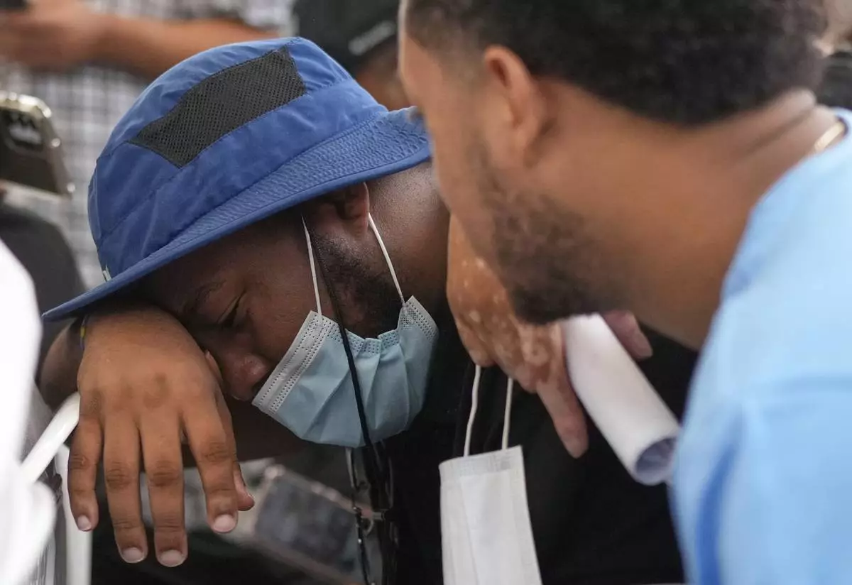 Family members wait at the morgue for the bodies of their loved one who died at the roof collapse of the Jet Set nightclub, where more than 200 people died, outside at the National Institute of Forensic Pathology in Santo Domingo, Dominican Republic, Friday, April 11, 2025. (AP Photo/Matias Delacroix)