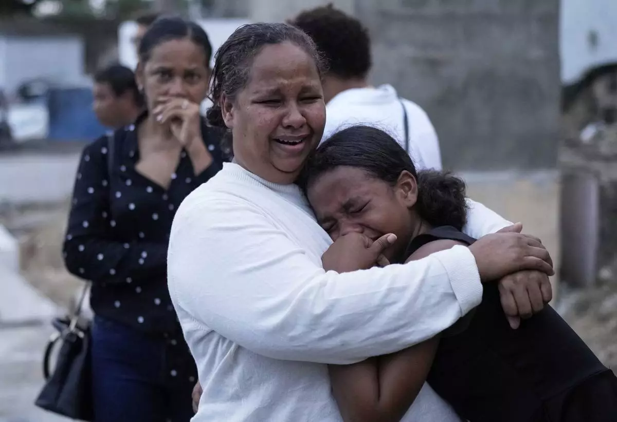Family and friends grieve during the burial service of Marilenny Pilarte who died at the Jet Set nightclub when its roof collapsed, in Haina, Dominican Republic, Thursday, April 10, 2025. (AP Photo/Matias Delacroix)