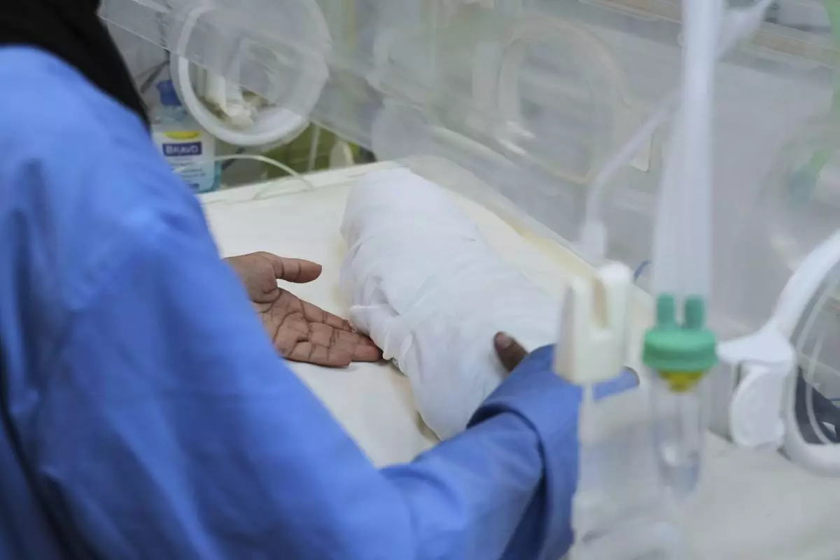 A nurse carries the body of a 15-days-old premature infant Sila Zidane after she died at Nasser Hospital in Khan Younis, Gaza, on Wednesday, April 23, 2025. (AP Photo/Abdel Kareem Hana)