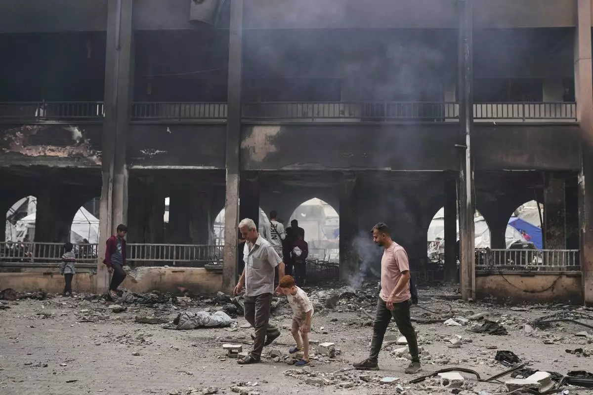 Palestinians inspect the damage after an Israeli army airstrike on Yaffa School, in Gaza City, Wednesday, April 23, 2025. (AP Photo/Jehad Alshrafi)