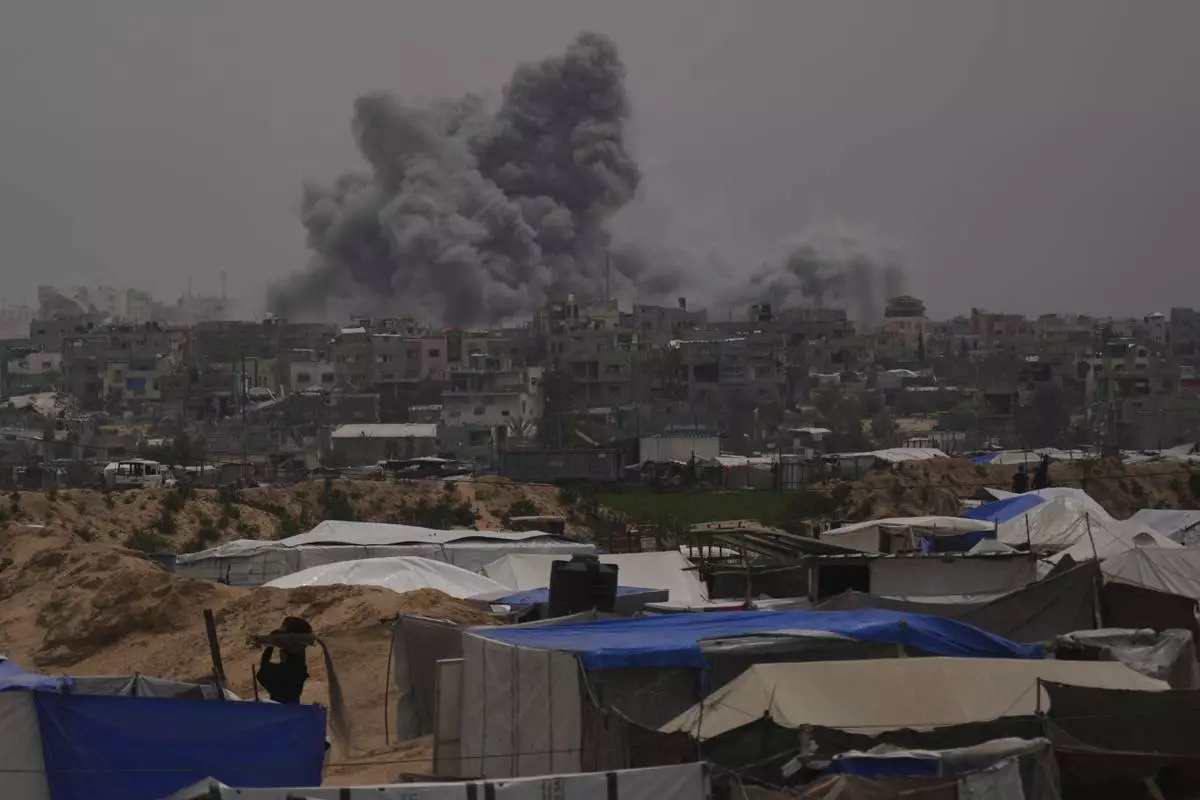 Smoke rises to the sky following an Israeli bombardment in Khan Younis, Gaza Strip, Thursday, April 24, 2025. (AP Photo/Abdel Kareem Hana)