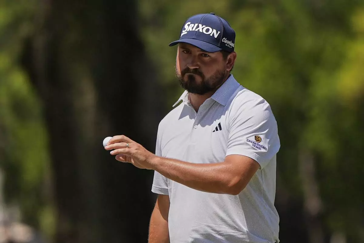 Andrew Novak waves to the gallery after making putt on the second hole during the final round of the RBC Heritage golf tournament, Sunday, April 20, 2025, in Hilton Head Island, S.C. (AP Photo/Mike Stewart)