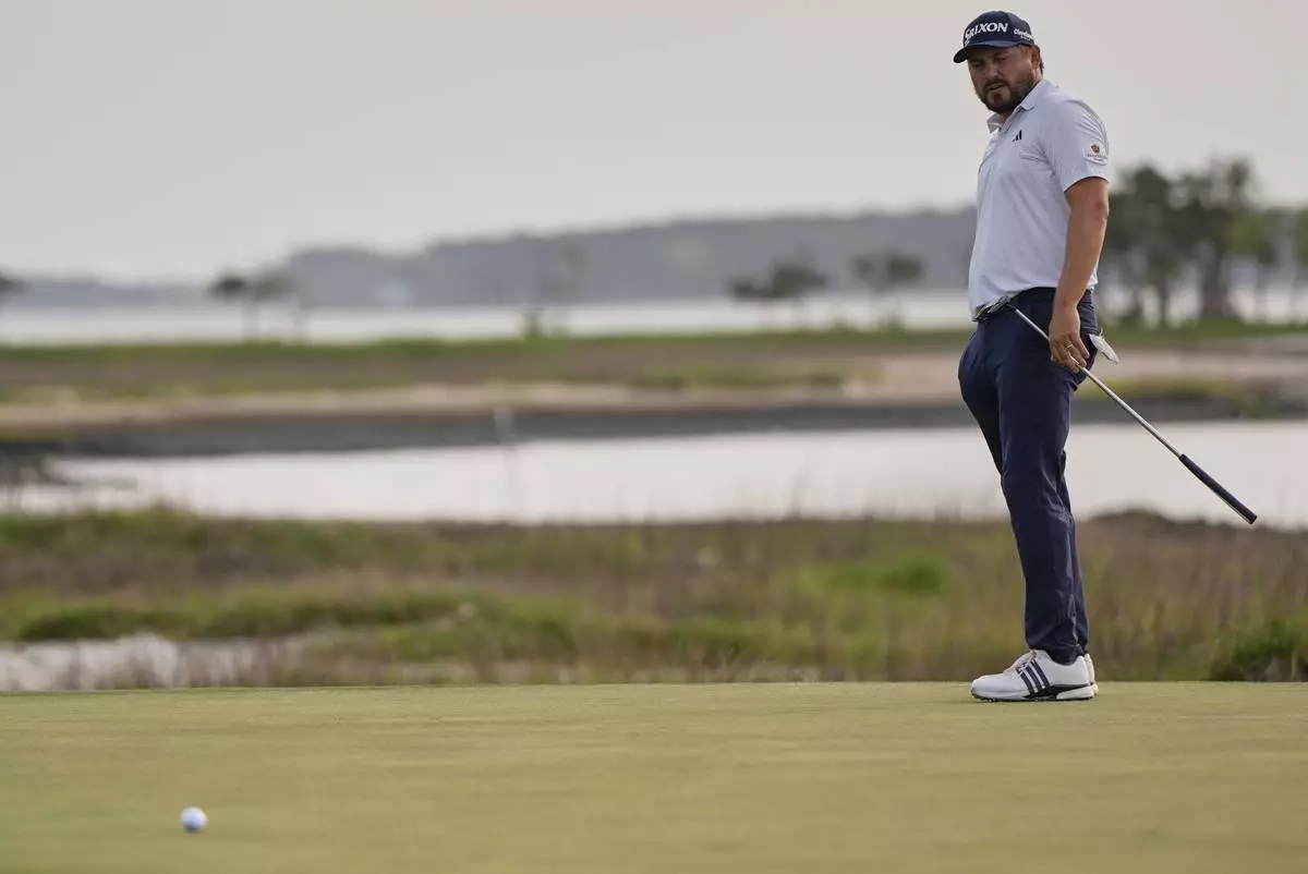 Andrew Novak watches his putt on the 18th hole during a playoff in the final round of the RBC Heritage golf tournament, Sunday, April 20, 2025, in Hilton Head Island, S.C. (AP Photo/Mike Stewart)