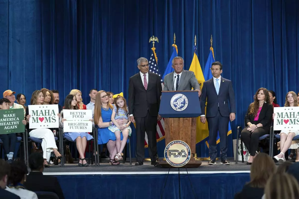 Health and Human Services Secretary Robert F. Kennedy Jr. flanked by Director of the National Institutes of Health Jay Bhattacharya, left, and Food and Drug Administration (FDA) commissioner Marty Makary, right, speaks during a news conference on the FDA's intent to phase out the use of petroleum-based synthetic dyes in the nation's food supply at the Hubert Humphrey Building Auditorium in Washington, Tuesday, April 22, 2025. (AP Photo/Jose Luis Magana)